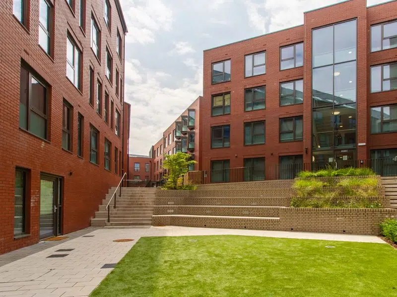 Steel City brick buildings surrounding a landscaped courtyard in Sheffield